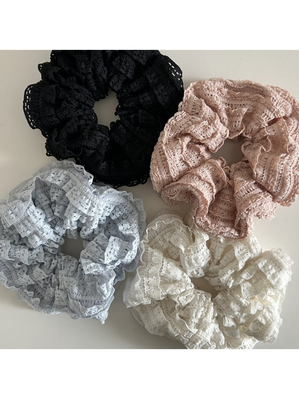 Close-up of Gifty Sweet Cutout Lace Scrunchie in white fabric with floral lace pattern