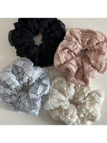 Close-up of Gifty Sweet Cutout Lace Scrunchie in white fabric with floral lace pattern