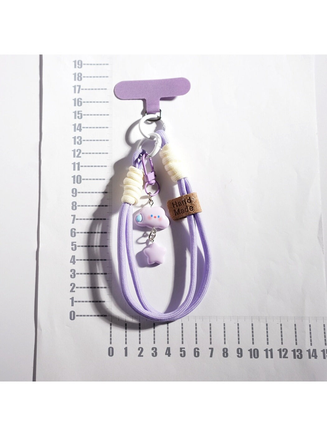 Close-up of cloud and star keychain showing smooth texture and metal ring