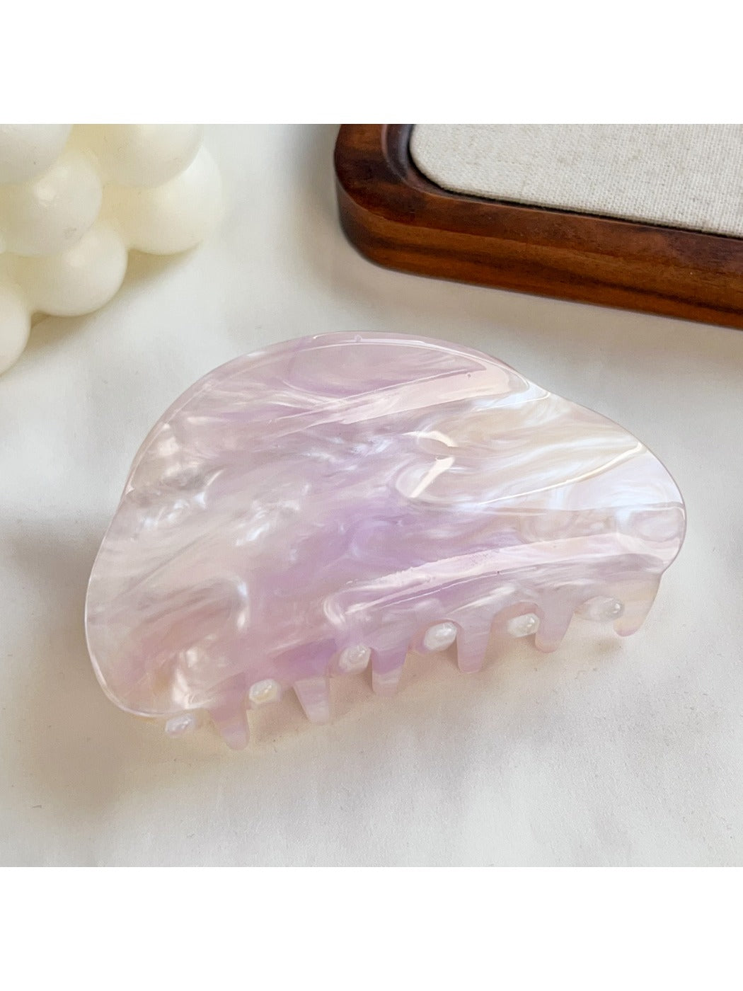 Beau hair claw clip with glossy finish and subtle cloud motifs