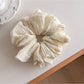 Flat lay of multiple Gifty printed ruched scrunchies in assorted colors