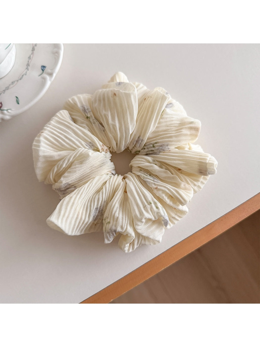 Flat lay of multiple Gifty printed ruched scrunchies in assorted colors