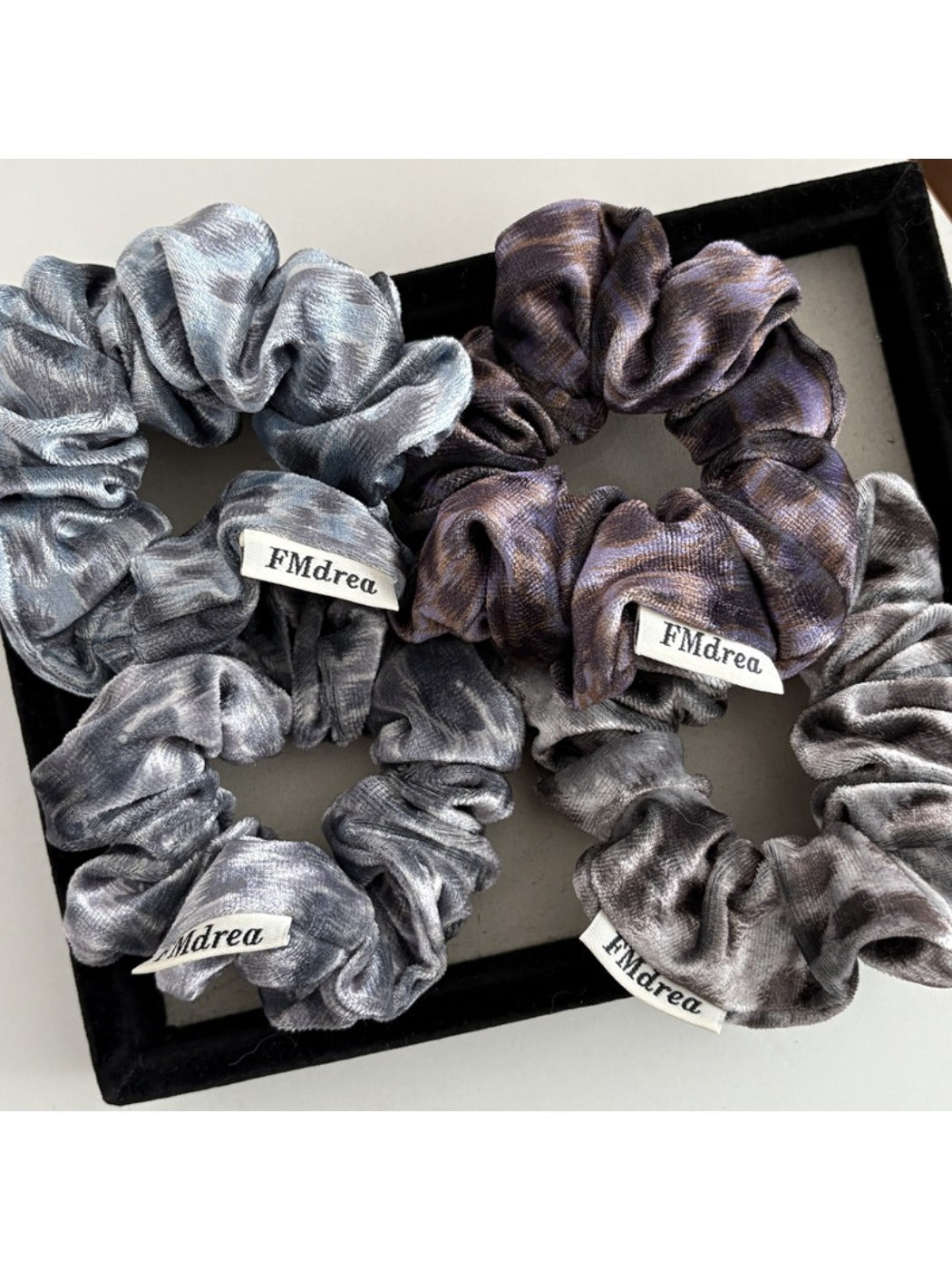 Close-up of Gifty Dreamy Silky Retro Scrunchie in soft pastel pink fabric