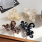 Side view of Beau elegant floral hair claw clip highlighting curved shape and clasp