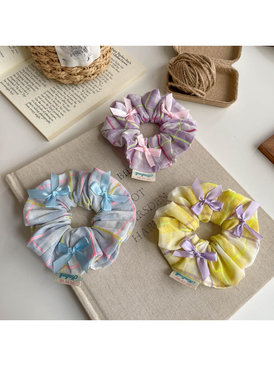 Gifty Ribbon Bow Plaid Scrunchie displayed on a wooden surface with natural lighting