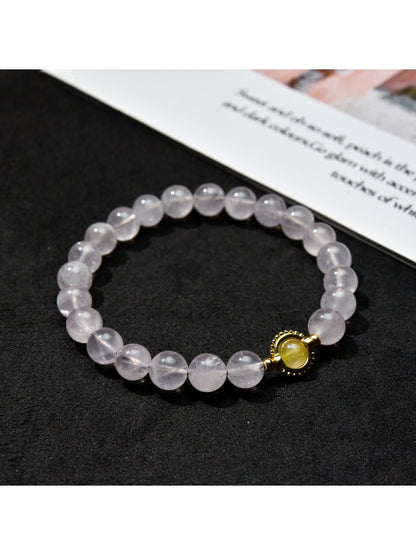 Close-up of Lovra pastel beaded bracelet showing smooth round beads in muted colors