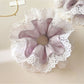 Gifty purple lace trim scrunchie styled on a model's wrist with casual outfit