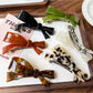 Beau hair clip open to show metal clasp mechanism and acetate bow