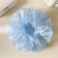 Gifty elegant solid color polka dot scrunchie in black with white dots on a white background