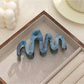 Beau elegant hair clip shown with packaging box and branding