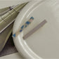 Beau hair clip positioned on fabric surface emphasizing smooth acetate texture