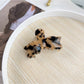 Beau sweet bow shaped hair claw clip displayed with minimalistic decor