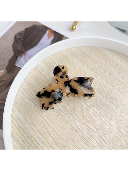 Beau sweet bow shaped hair claw clip displayed with minimalistic decor