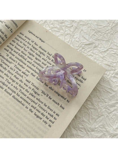 Top view of Beau romantic butterfly shaped claw clip showing smooth acetate finish