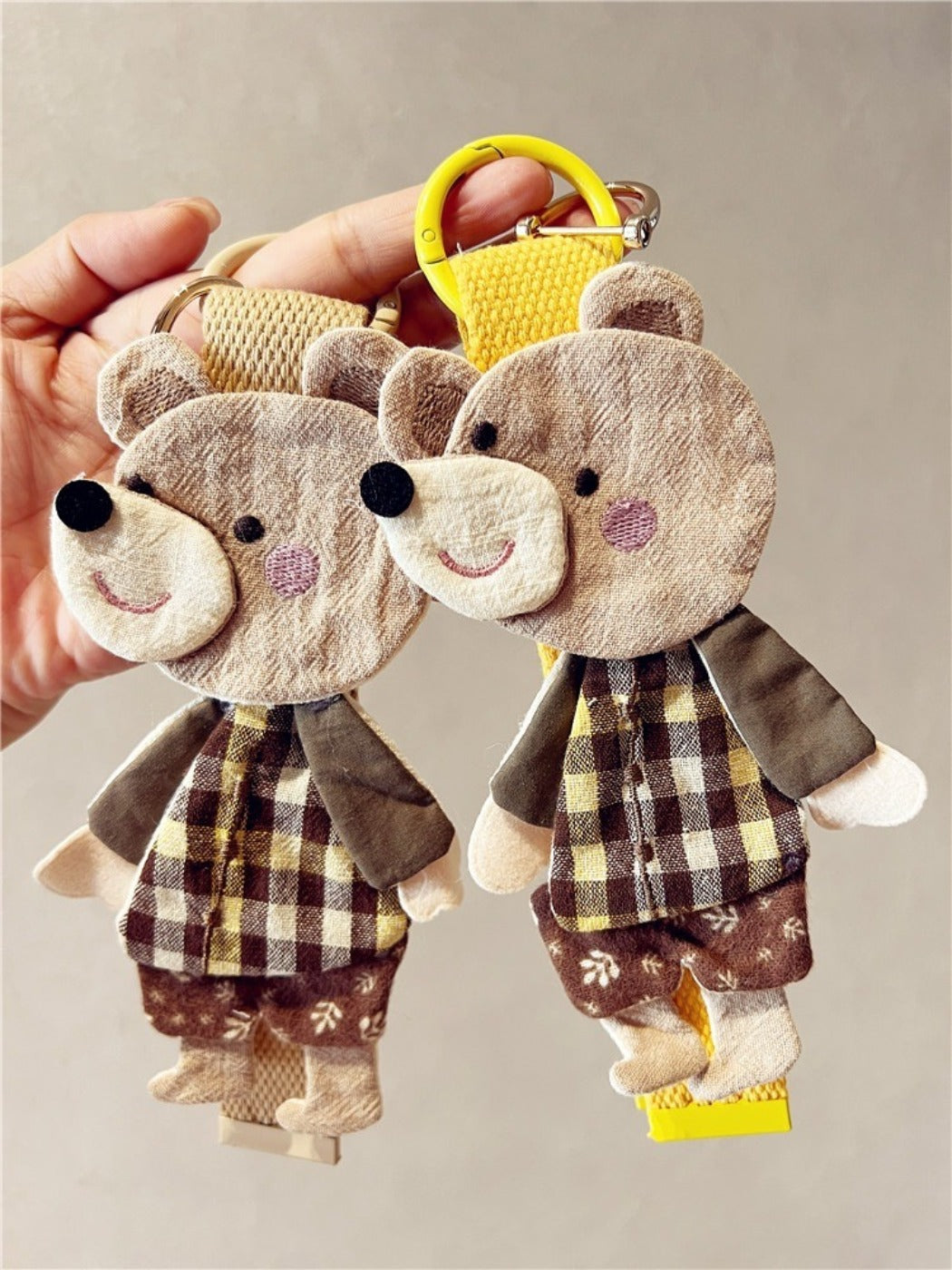 Front view of a cute fabric patchwork bear keychain with colorful stitched patterns