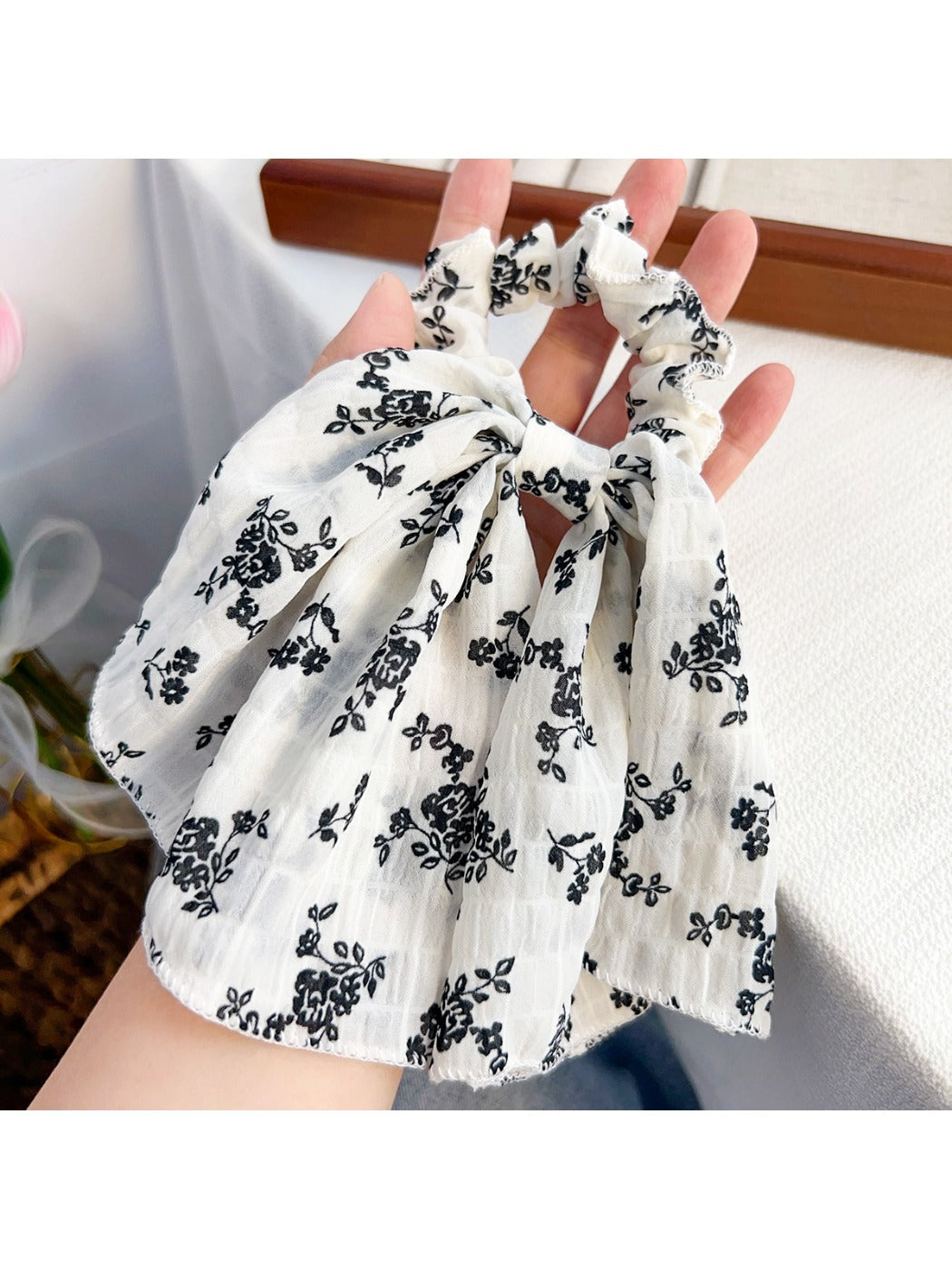 Gifty scrunchie showing elastic stretch and floral print details