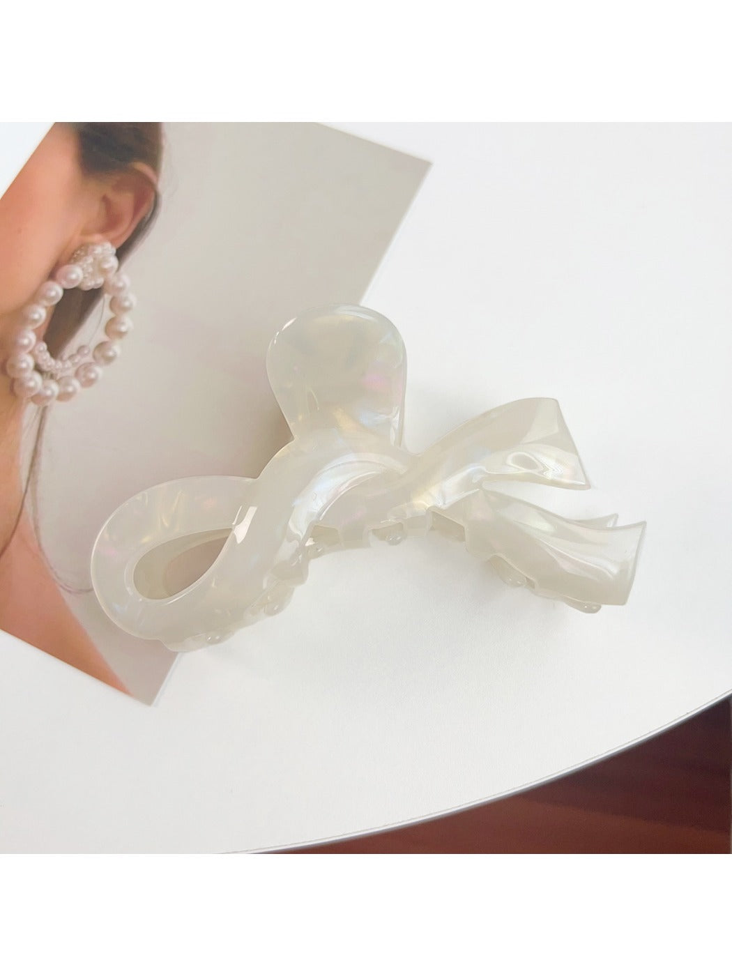 Beau hair claw clip in pastel pink with metal spring mechanism visible