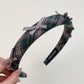 Gifty plaid bow headband styled with hair in a ponytail