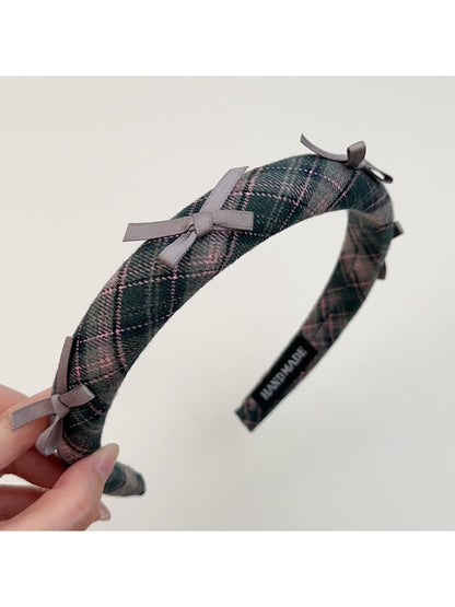 Gifty plaid bow headband styled with hair in a ponytail
