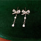 Earedge - Alloy Bow Stud Earrings with Drop Detail Earrings