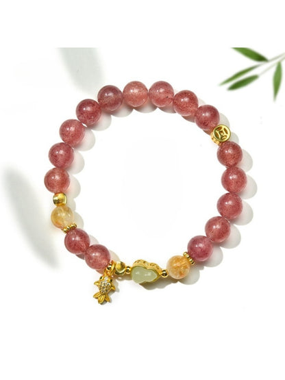 Lovra minimalist goldfish pendant on a delicate crystal bead bracelet