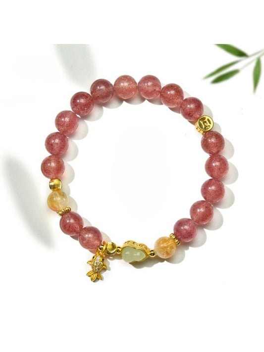 Lovra minimalist goldfish pendant on a delicate crystal bead bracelet