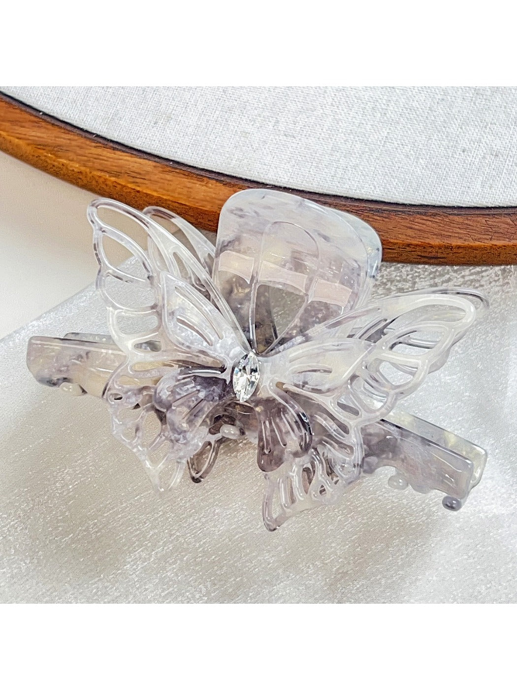 Beau butterfly decorated hair claw clip photographed with soft lighting