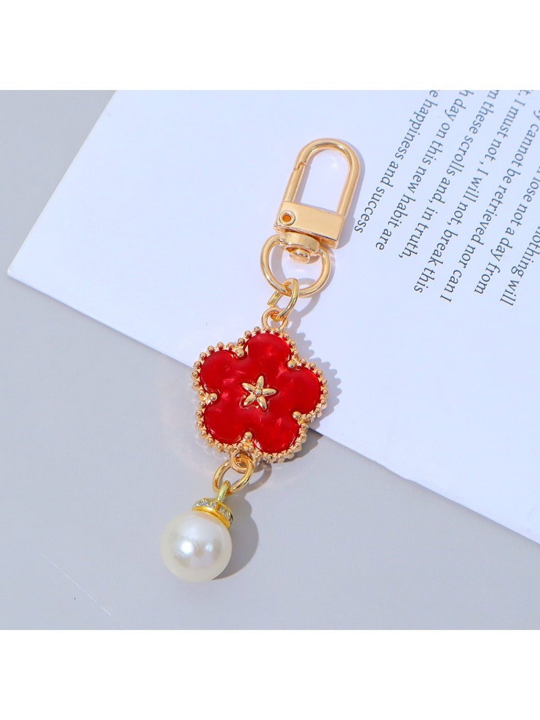 Keypus colorful flower charm keychain held in a hand showing size and detail