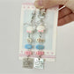 Three fish-shaped keychains in pastel colors attached to a metal ring
