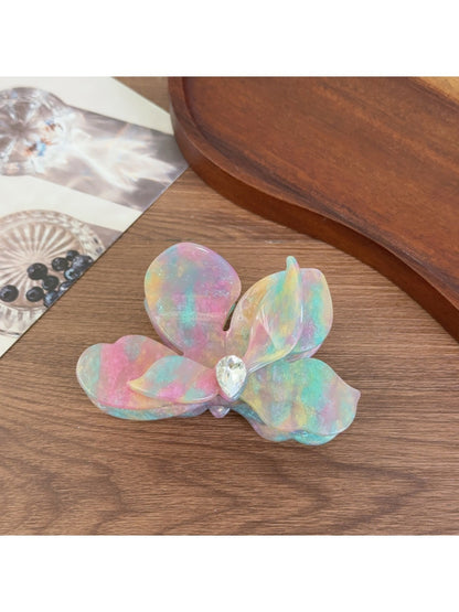 Beau acetate moth orchid claw clip held in hand showing size and shape