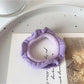 Close-up of fabric texture on a red ruffled hair tie