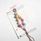 Flat lay of a resin bead keychain with bright, assorted beads