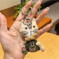 Vintage cat charm keychain next to a ruler showing compact size