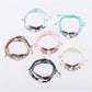 Close-up of Lovra beaded woven cord bracelet with multicolored beads on black cord