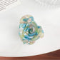 Beau Sweet Rose hair claw clip with pink rose decoration angled to show clip teeth
