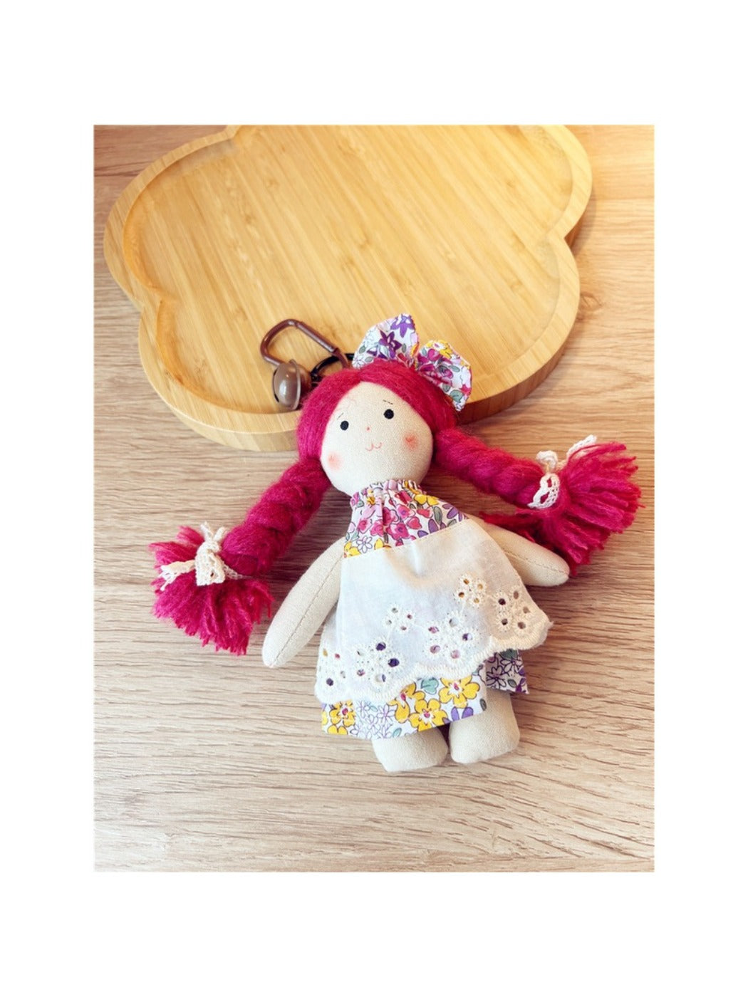 Keypus cartoon doll keychain displayed on a wooden surface with keyring visible
