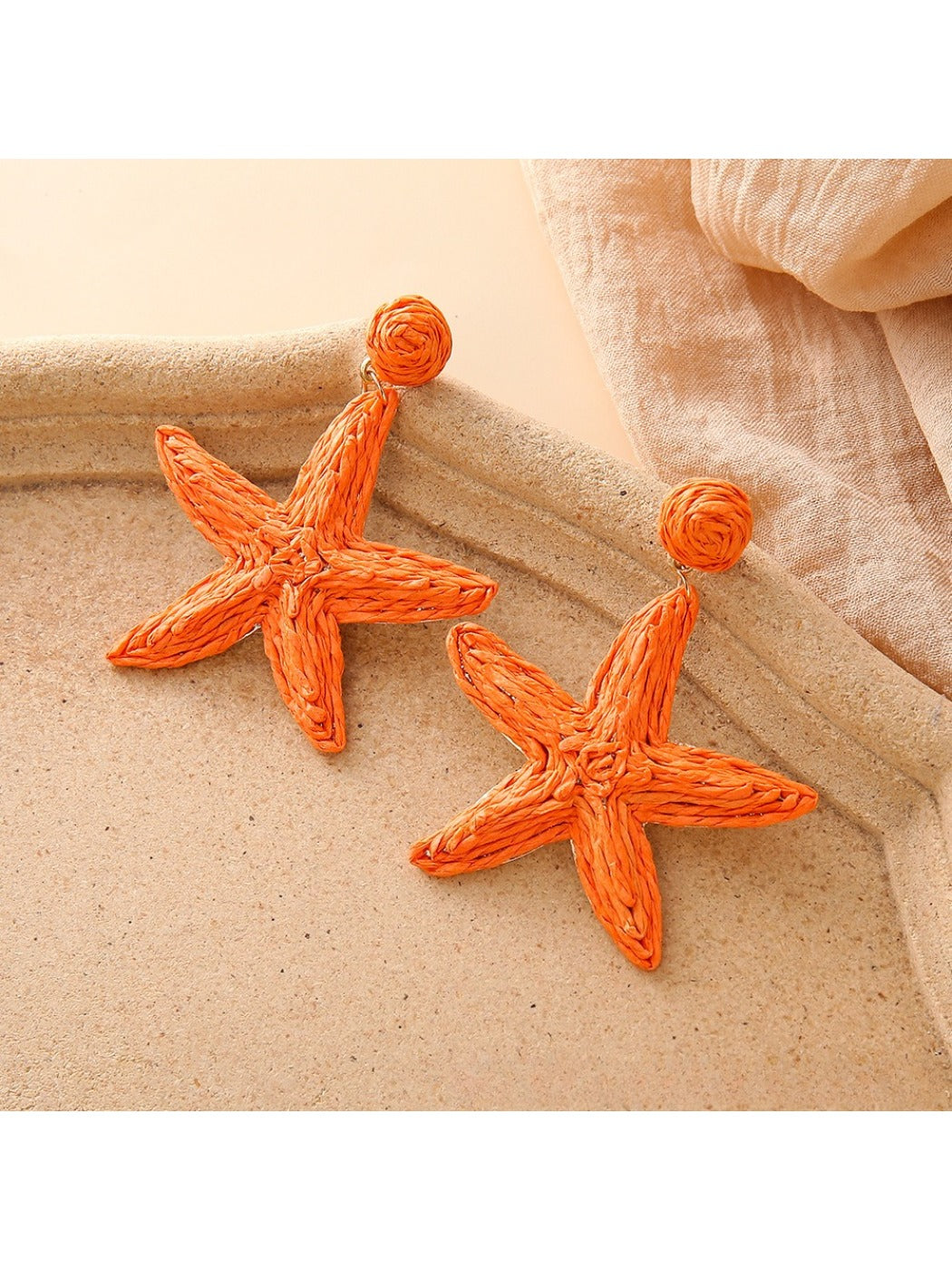 Pair of starfish shaped drop earrings with polished silver finish