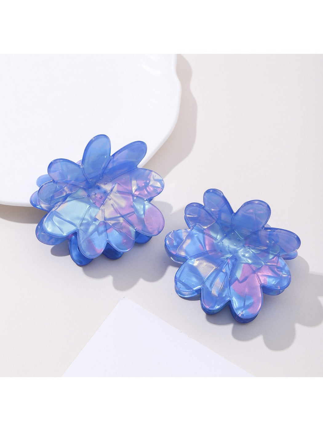 Close-up of blue flower hair clip showing petal texture and clip mechanism