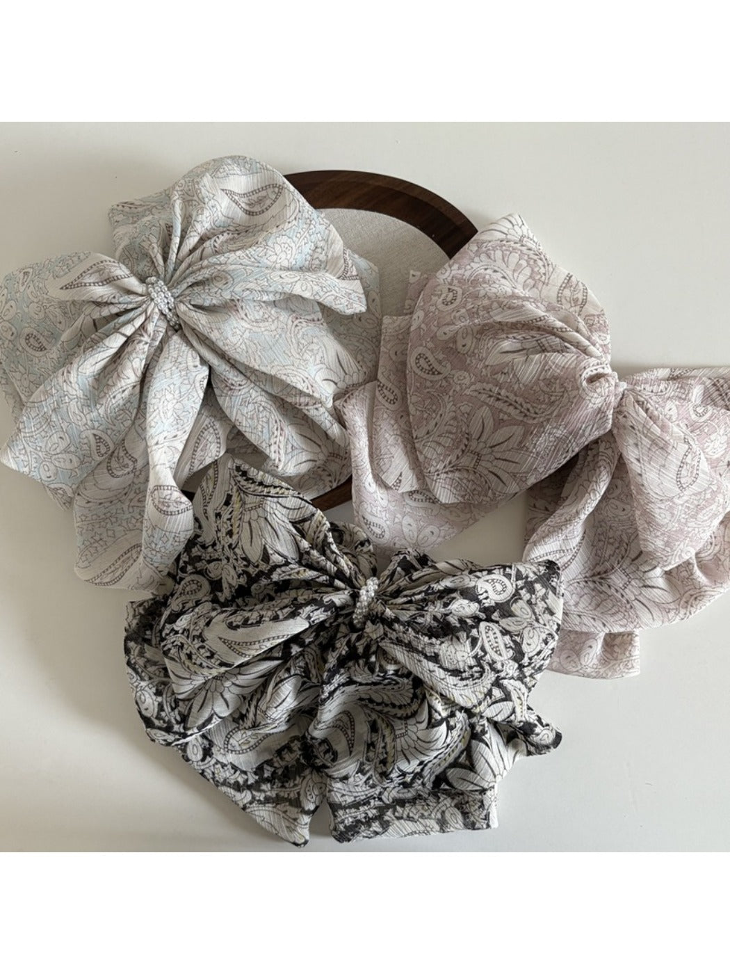 Beau chiffon bow shaped claw clip in soft pastel pink on white background
