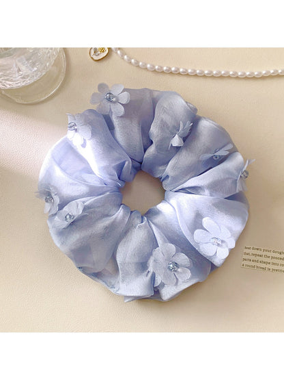 Gifty ruched scrunchie with floral accents styled on a wrist