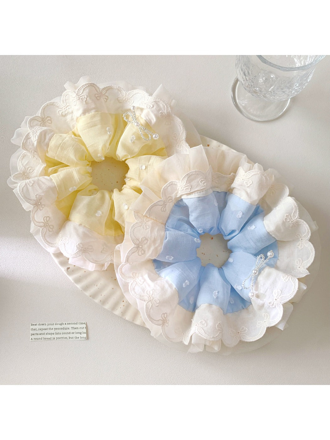 Close-up of Gifty elegant minimalist polka dot scrunchie in white with black dots