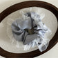 Gifty vintage tulle ruffle scrunchie displayed in natural light on a wooden surface