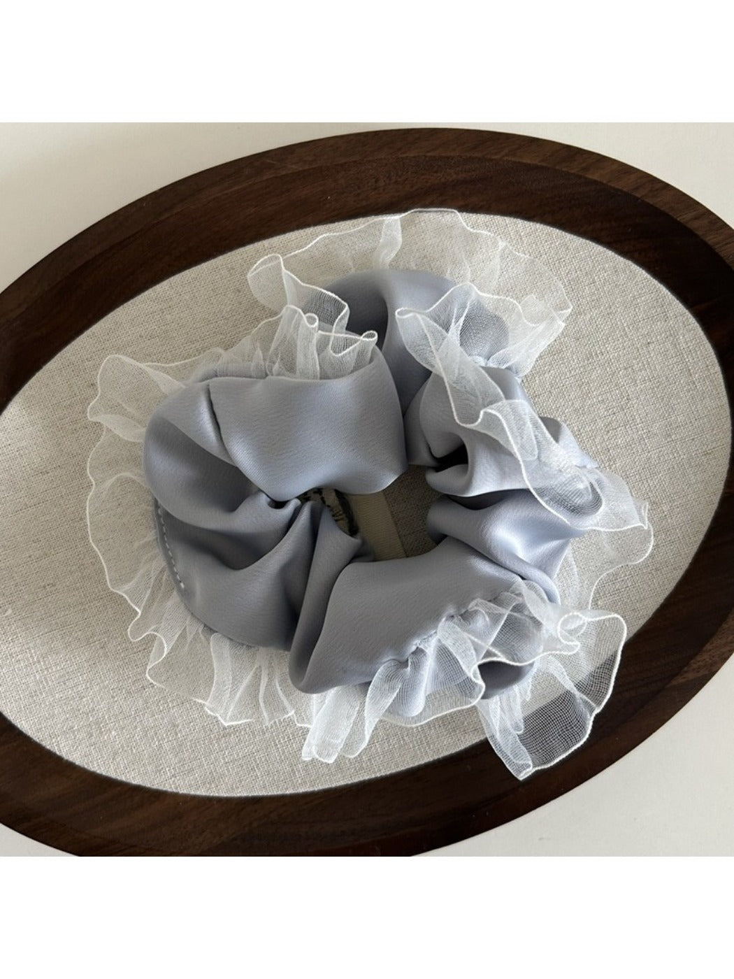 Gifty vintage tulle ruffle scrunchie displayed in natural light on a wooden surface