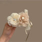 White flower shaped hair clip with detailed petals and a glossy finish