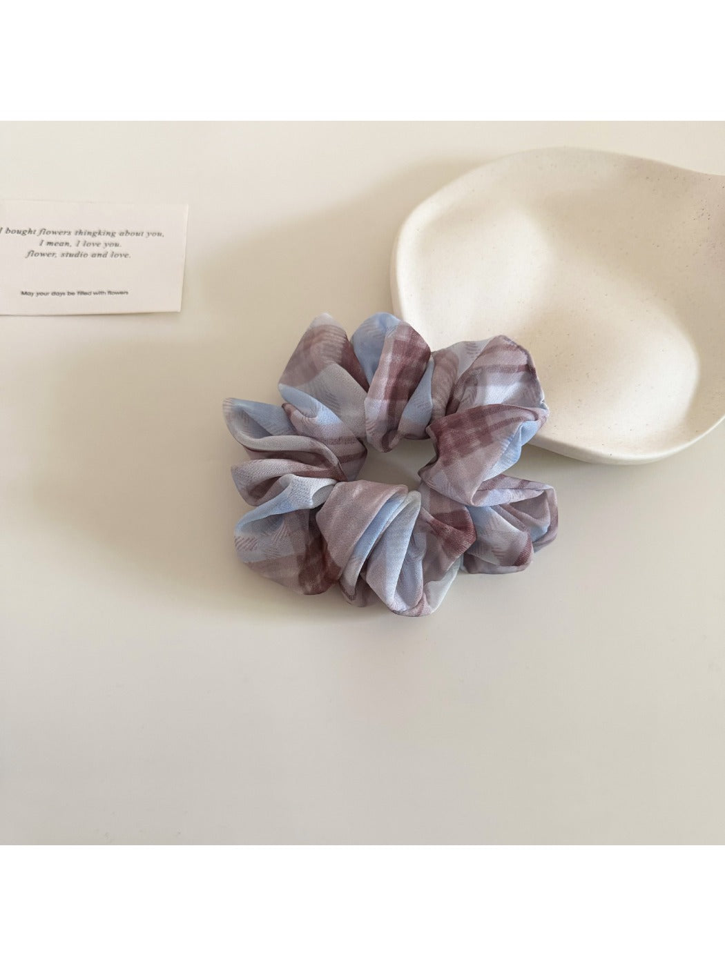 Close-up of Gifty scrunchie elastic band inside checkered fabric