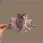 Beau tulle flower shaped claw clip in soft pink on white background