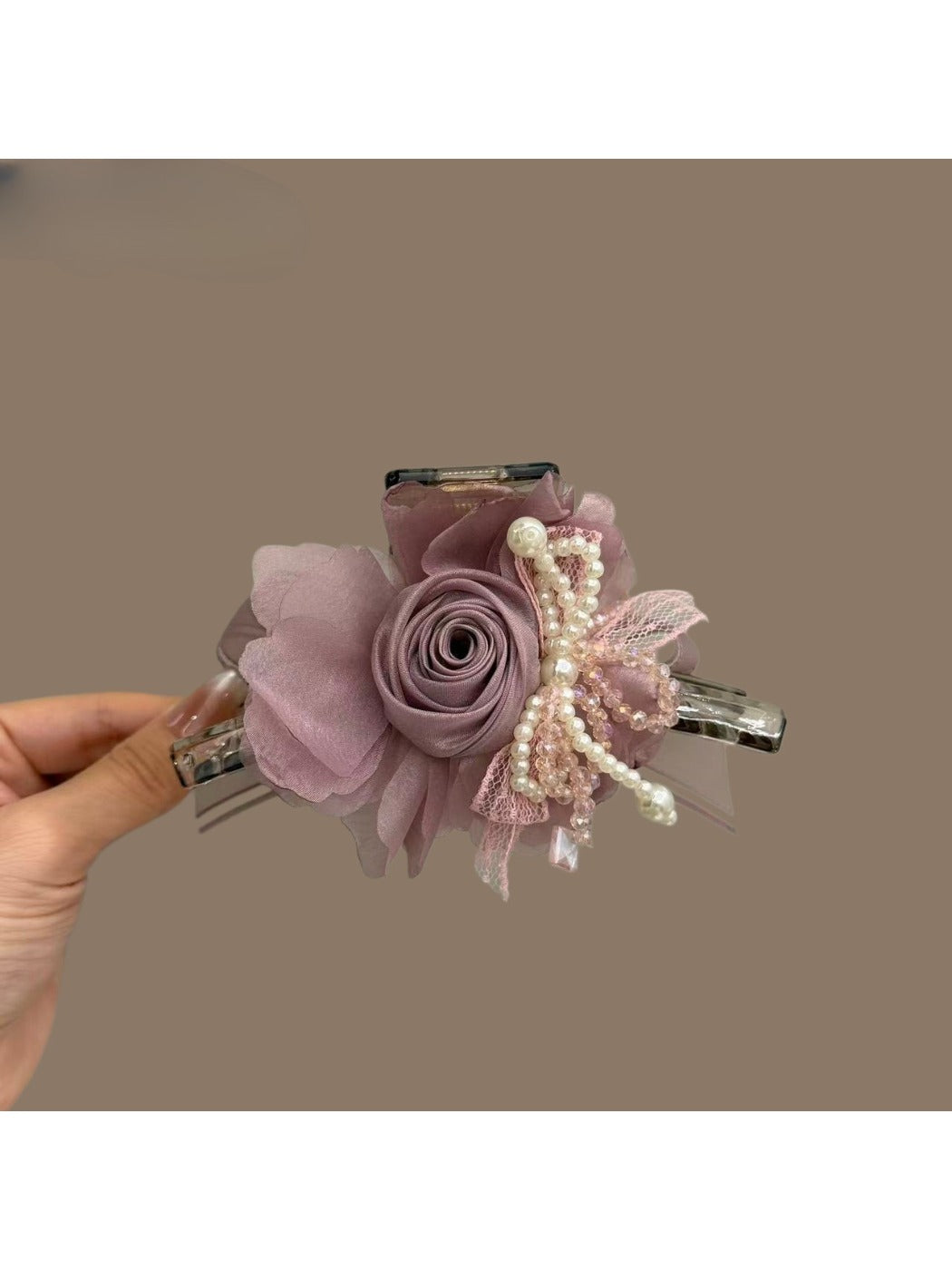 Beau tulle flower shaped claw clip in soft pink on white background