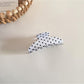 Beau hair clip worn in styled hair, showcasing size and decorative effect