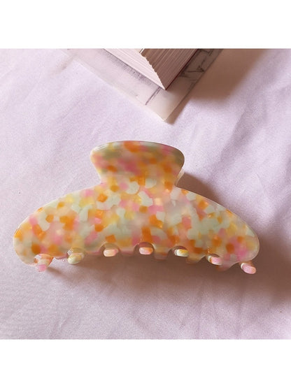 Beau chic tiny floral acetate claw clip photographed with soft shadows