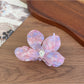 Beau acetate moth orchid claw clip worn in hair styled in loose waves